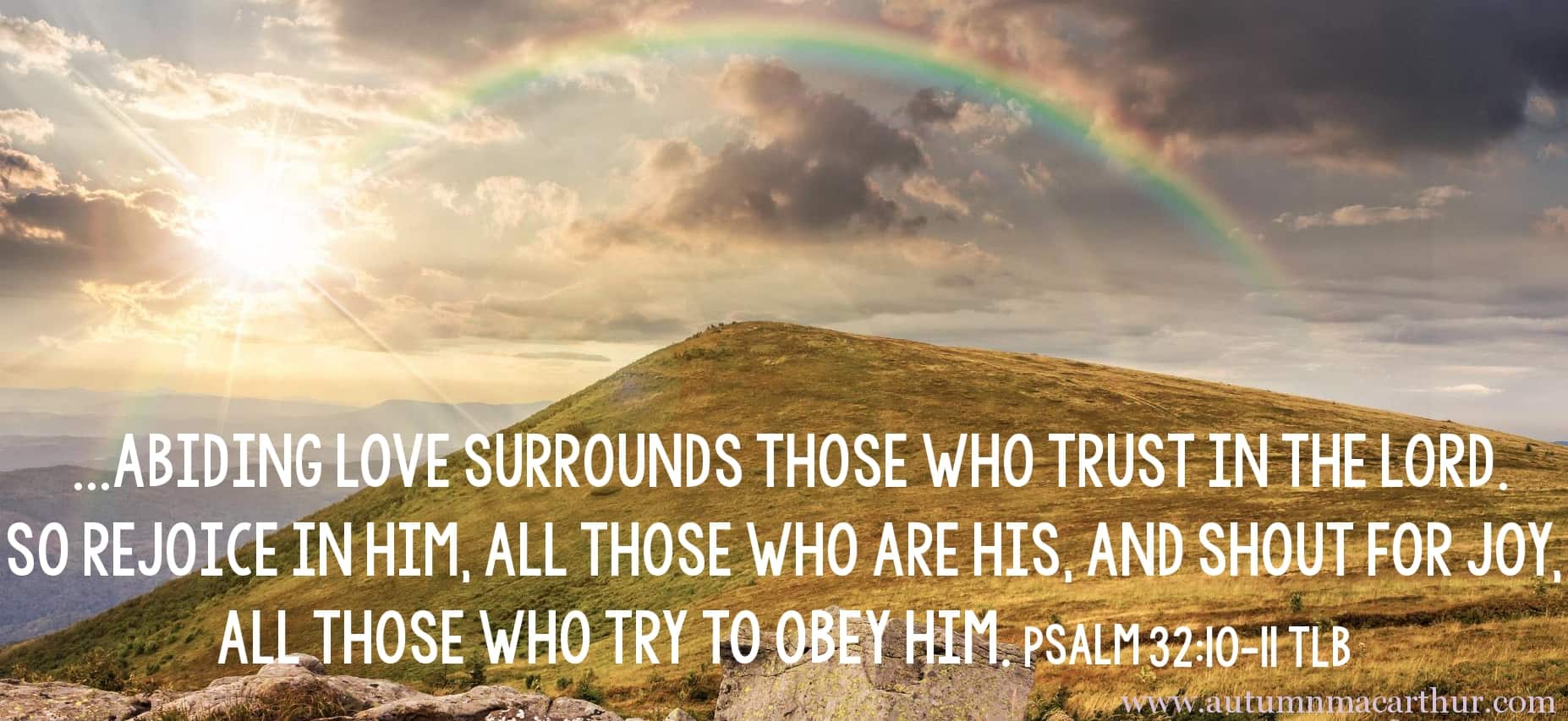 Image of rainbow on hilltop with Bible verse Psalm 32:10-11 by inspirational romance author Autumn Macarthur for Inspy Romance